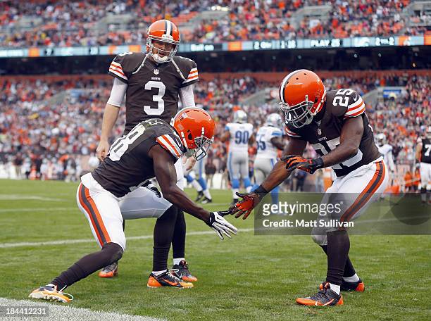 Wide receiver Greg Little of the Cleveland Browns celebrates after scoring a touchdown with fullback Chris Ogbonnaya and quarterback Brandon Weeden...
