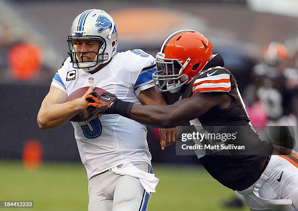 Quarterback Matthew Stafford of the Detroit Lions is hit by linebacker Barkevious Mingo of the Cleveland Browns at FirstEnergy Stadium on October 13,...