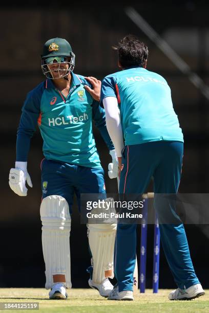 David Warner shares a moment with Mitchell Starc during an Australian nets session the at the WACA on December 10, 2023 in Perth, Australia.