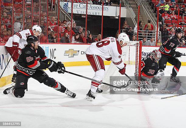 David Moss of the Phoenix Coyotes attempts a wraparound as Cam Ward of the Carolina Hurricanes makes the save during an NHL game at PNC Arena on...