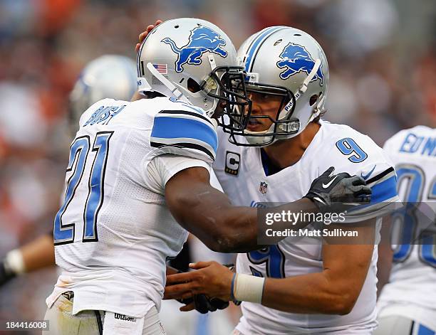 Quarterback Matthew Stafford of the Detroit Lions celebrates a touchdown by running back Reggie Bush against the Cleveland Browns at FirstEnergy...