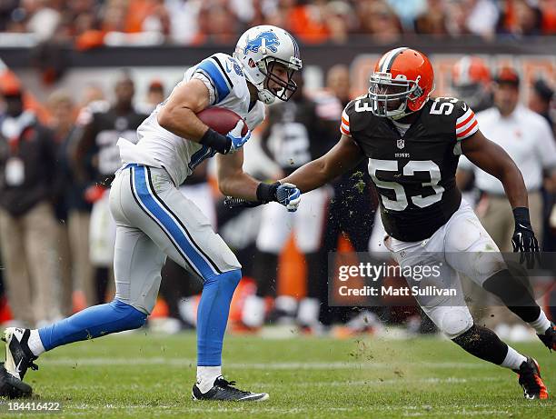 Wide receiver Kris Durham of the Detroit Lions runs the ball by linebacker Craig Robertson of the Cleveland Browns at FirstEnergy Stadium on October...