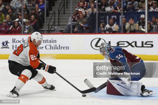 Goalie Ivan Prosvetov of the Colorado Avalanche saves a shot on goal by Cam Atkinson of the Philadelphia Flyers in the third period at Ball Arena on...