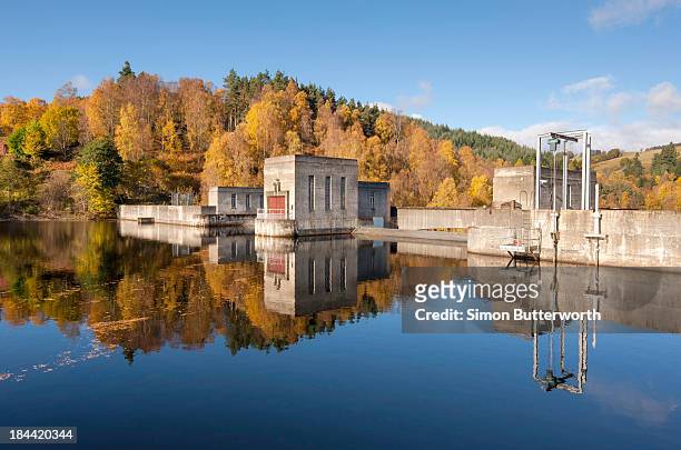 hydro electric dam in autumnal landscape. - loch tummel stock pictures, royalty-free photos & images