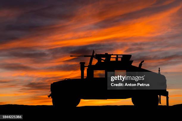 military vehicle humvee at sunset - battlefield stock pictures, royalty-free photos & images