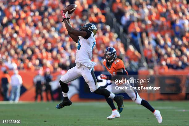 Wide receiver Justin Blackmon of the Jacksonville Jaguars makes a first down pass reception as free safety Rahim Moore of the Denver Broncos defends...