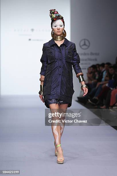 Model walks the runway at the Royal Closet Spring/Summer 2014 collection during the fourth day of Mercedes-Benz Fashion Week Mexico at Campo Marte on...