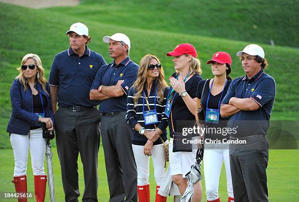 Amy Mickelson, Phil Mickelson, U.S. Team captain Fred Couples, Nadine Moze, Kim Johnson, Amanda Dufner and Jason Dufner of the U.S. Team follow the...