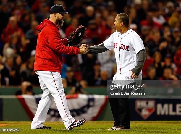 Former player Dave Roberts greets David Ross of the Boston Red Sox after throwing out the ceremonial first pitch prior to Game Two of the American...