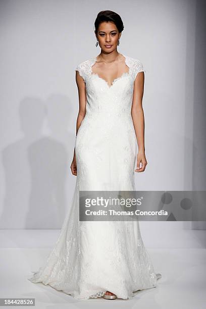 Model walks the runway at the Matthew Christopher Couture Fall 2014 Bridal collection show at the Hilton New York on October 13, 2013 in New York...