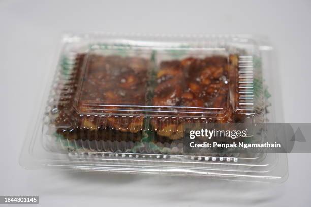 toffee cake in clear plastic box - cashew pieces stock pictures, royalty-free photos & images