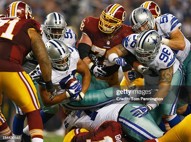 Kyle Wilber of the Dallas Cowboys recovers the ball fumbled by Robert Griffin III of the Washington Redskins in the fourth quarter on October 13,...