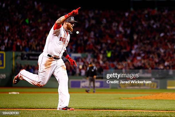 Jonny Gomes of the Boston Red Sox scores the winning run against the Detroit Tigers in Game Two of the American League Championship Series at Fenway...