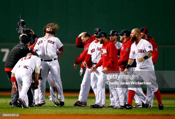 The Boston Red Sox celebrate after defeating the Detroit Tigers 6-5 in Game Two of the American League Championship Series at Fenway Park on October...