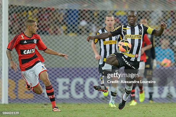 Paulinho of Flamengo fights for the ball with Seedorf of Botafogo during the match between Flamengo and Botafogo for the Brazilian Series A 2013 at...