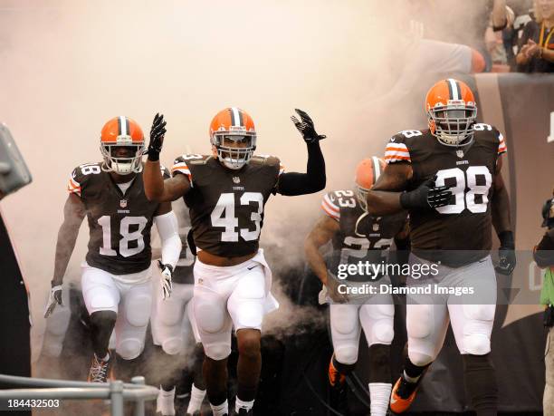 Wide receiver Greg Little, safety T.J. Ward, cornerback Joe Haden, and defensive tackle Phil Taylor of the Cleveland Browns runs onto the field after...