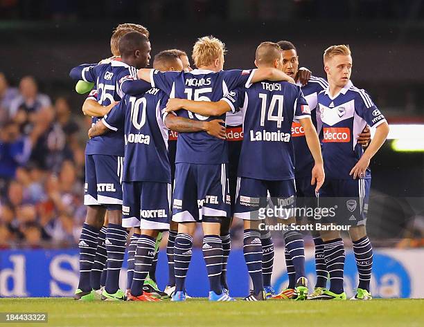 Victory players form a huddle before the round one A-League match between the Melbourne Victory and the Melbourne Heart at Etihad Stadium on October...