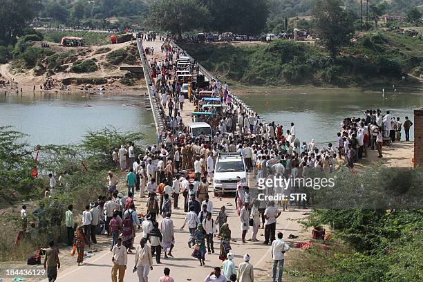 Indian police and bystanders gather on a bridge where Hindu devotees were crushed in a stampede outside the Ratangarh Temple at Datia district in...