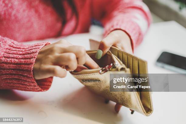 female hand reach for a piece of chocolate cake on plate.top view - portafoglio foto e immagini stock