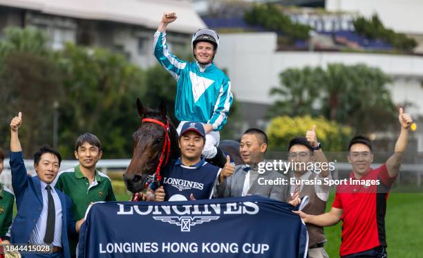 Jockey James McDonald rides Romantic Warrior, and horse trainer Danny Shum Chap-shing celebrates after winning the LONGINES Hong Kong Cup of the...