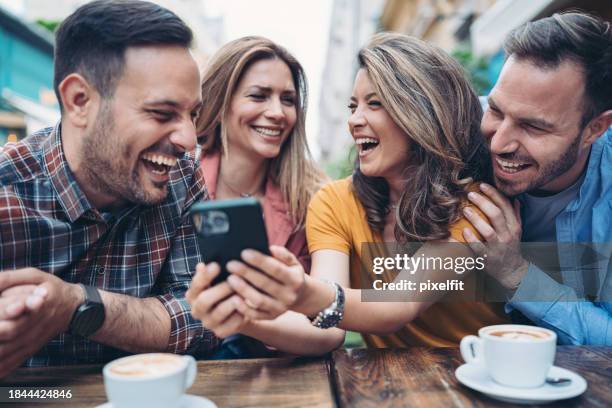 friends watching funny social media content - meme text stock pictures, royalty-free photos & images