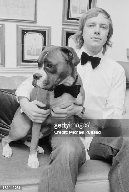 English lyricist Tim Rice and his boxer dog, both wearing bow ties, 12th October 1973.