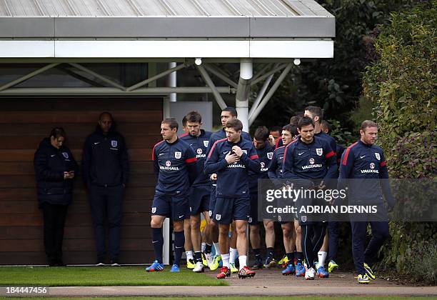 England players arrive for a training session at Arsenal's training complex in London Colney on October 14 a day ahead playing their last 2014 World...