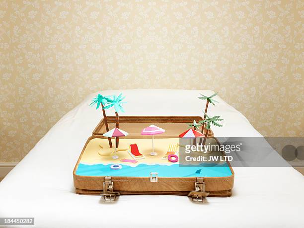 tropical beach scene inside a suitcase - vacation luggage stock-fotos und bilder