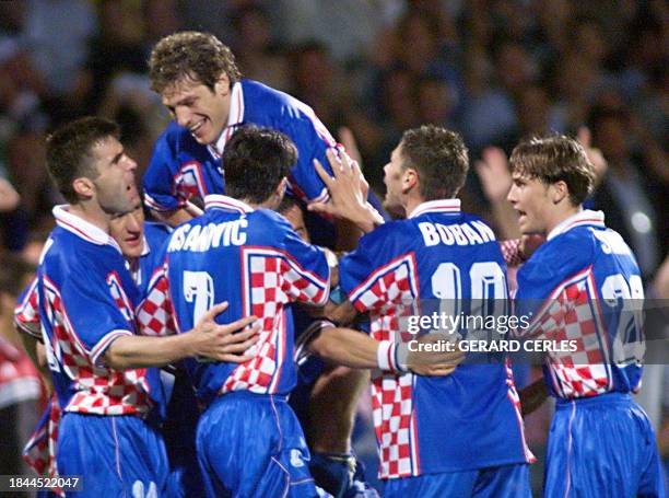 Slaven Bilic jumps over a happy Croatian squad after a surprising 3-0 victory against Germany in the quarter-finals of the 16th FIFA World Cup, 04...