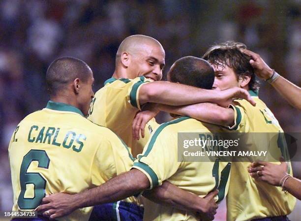 Brazilian Romario is congratulated by teammates Ronaldo , Roberto Carlos and Leonardo , after he scored the first goal for his team against England...