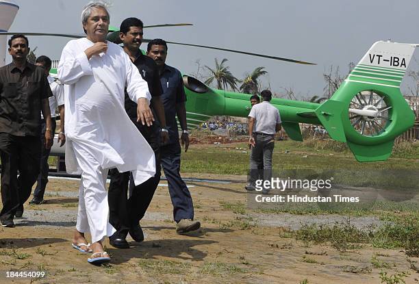Odisha Chief Minister Naveen Patnaik coming out of chopper after aerial survey of the Phailin affected Ganjam district on October 14, 2013 in...