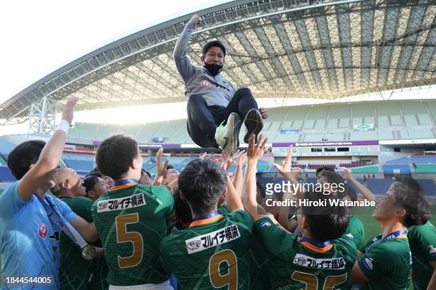 Masanori Masaki,coach of Aomori Yamada is lifted up after the Prince Takamado Trophy JFA U-18 Football Premier League final between Aomori Yamada and...