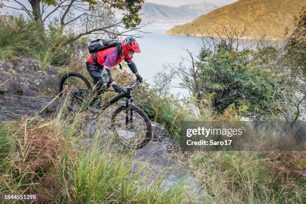 mountain bike downhill at lake maggiore. - shin guard stock pictures, royalty-free photos & images