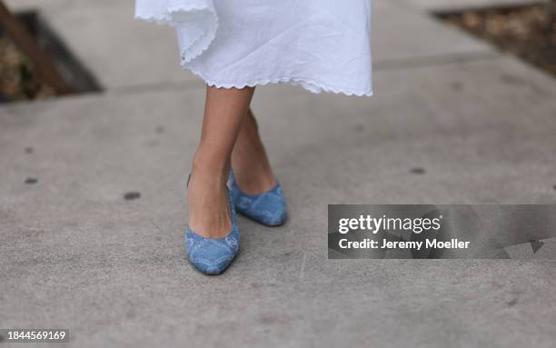 Jessica De Oliveira seen wearing Riani white strappy long dress and Chanel denim logo print pattern ballerinas, on December 09, 2023 in Miami,...