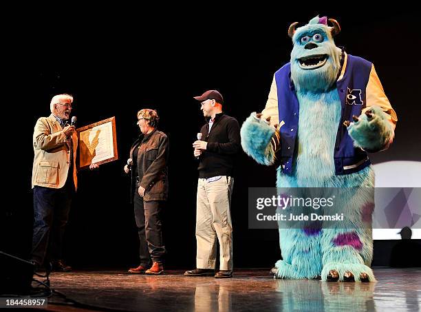 Bill Pence presents the Dartmouth Film Award to Producer Kori Rae, Director Dan Scanlon and the Pixar character James P. Sullivan at a "A Tribute To...