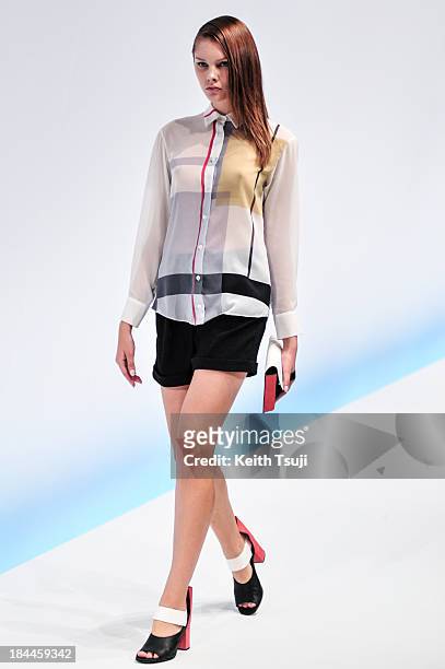 Model showcases designs on the runway during the Yasutoshi Ezumi show as part of Mercedes Benz Fashion Week Tokyo S/S 2014 at Hikarie Hall B of...