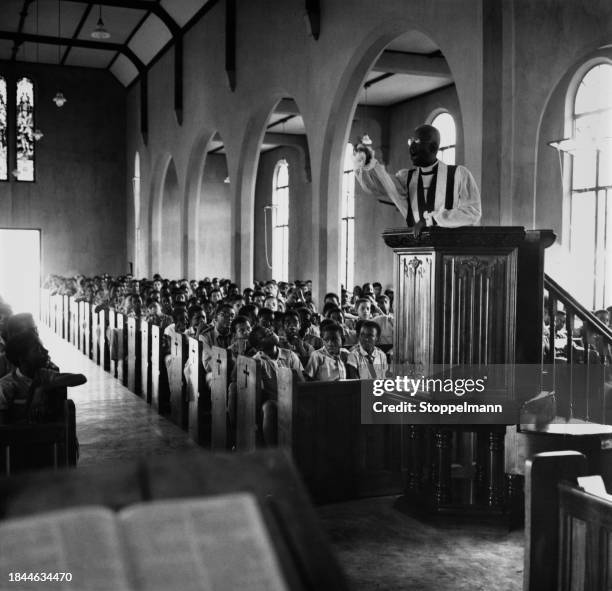 Jamaican Anglican Bishop Percival Gibson preaches from the pulpit of the chapel at Kingston College in Kingston, Jamaica, circa 1965. The...