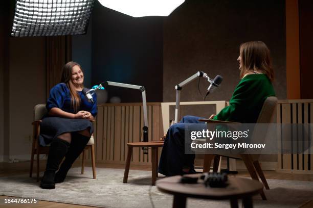 positive women chatting while recording podcast - entrevista imagens e fotografias de stock
