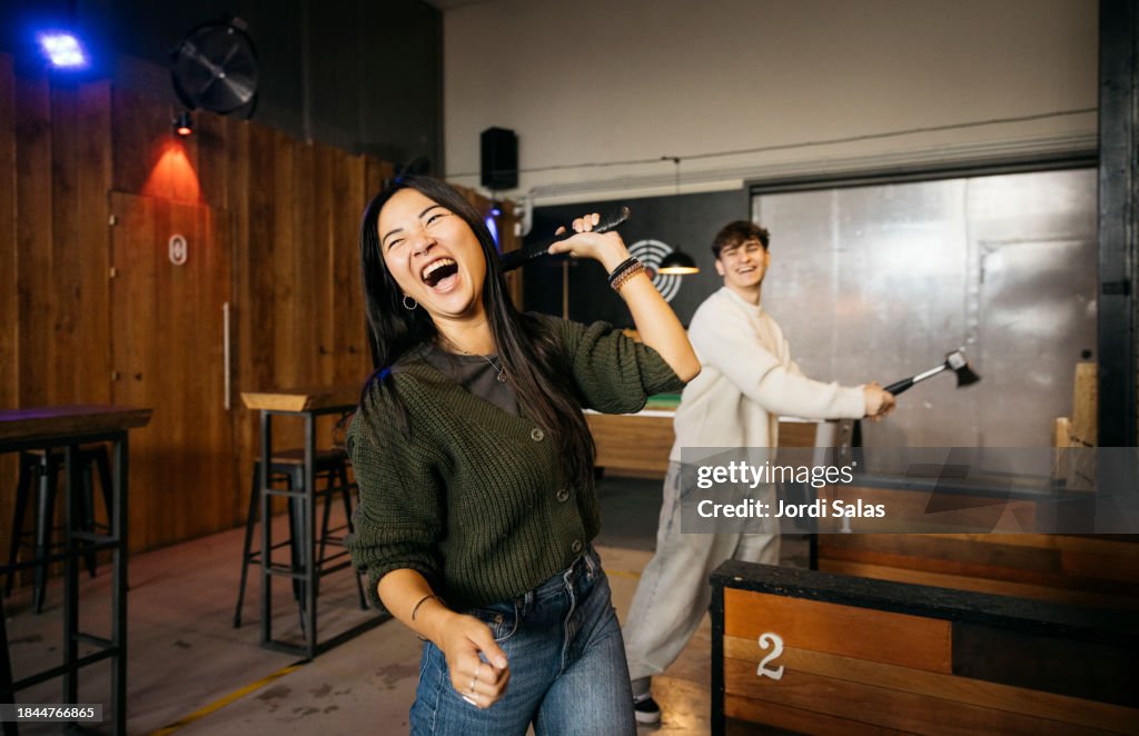 Axe throwing competition between friends.