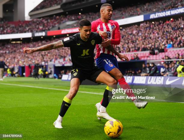 Chumi of UD Almeria battles for possession with Samuel Lino of Atletico Madrid during the LaLiga EA Sports match between Atletico Madrid and UD...