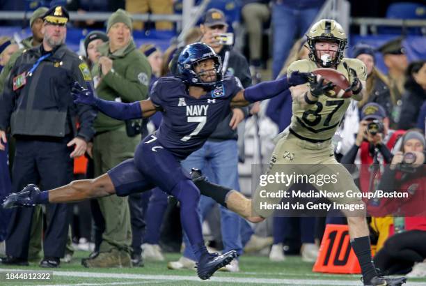 Foxboro, MA- Navy Midshipmen defensive end Mbiti Williams Jr. Tips the ball away from Army Black Knights wide receiver Casey Reynolds as Army takes...