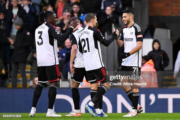 Raul Jimenez of Fulham celebrates with teammates after scoring their team's first goal during the Premier League match between Fulham FC and West Ham...