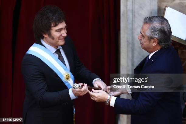 Outgoing President of Argentina Alberto Fernandez hands the Presidential cane to President elect Javier Milei during his Inauguration Ceremony at...