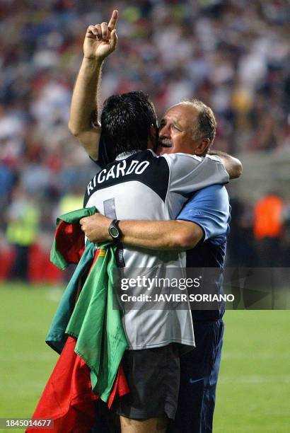 Portugal head coach Luiz Felipe Scolari congratulates Portugal's goalkeeper Ricardo after he scored the winning penalty, 24 June 2004 during their...