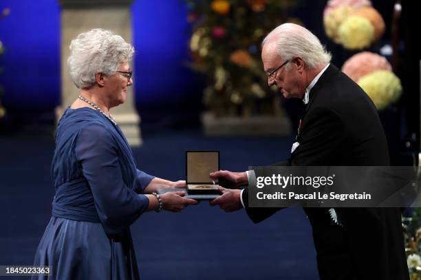 Anne L'Huillier receives The Nobel Prize in Physics 2023 from King Carl XVI Gustaf of Sweden at the Nobel Prize Awards Ceremony 2023 at Stockholm...