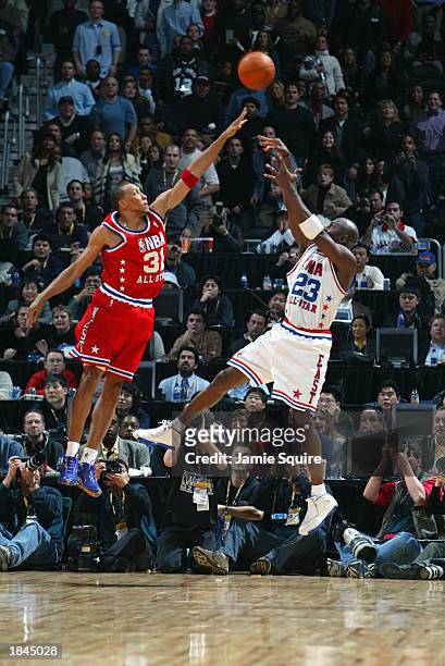 Michael Jordan of the Eastern Conference All-Stars puts a shot up over Shawn Marion the Western Conference All-Stars to take the game into overtime...
