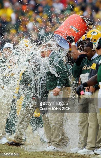 Head coach Mike Sherman of the Green Bay Packers is soaked with water after his team's victory over the San Francisco 49ers 13 January, 2002 during...