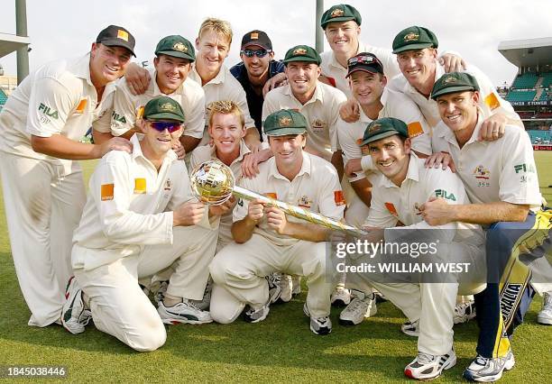 The Australian cricket team display the ICC World Championship Test Trophy after defeating South Africa on the fourth day of the third Test Match...