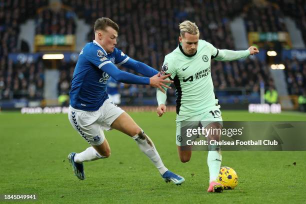 Mykhaylo Mudryk of Chelsea is challenged by Nathan Patterson of Everton during the Premier League match between Everton FC and Chelsea FC at Goodison...