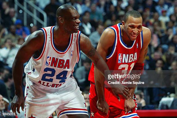Jamal Mashburn of the Eastern Conference All-Stars jokes with Shawn Marion of the Western Conference All-Stars at the 2003 NBA All-Star Game on...